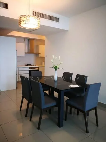 Dining features: black dining table, 6 upholstered dining chairs in grey, pendant light fixture, white walls, grey tiled flooring, kitchen area visible in background, decorative vase with flowers; style: modern. Kitchen features: white cabinetry, stainless-steel range hood, built-in oven, gas stove, countertop, kitchen island; style: modern.