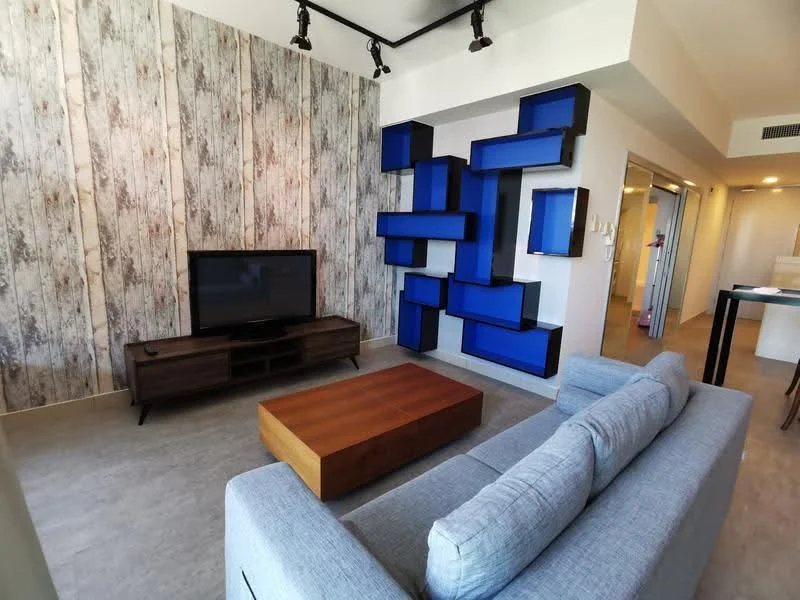 Living features: grey fabric sofa, wood coffee table, wall-mounted TV, wood TV console, decorative wall with wood paneling, accent wall with blue shelving units, recessed ceiling lights, light-colored flooring; style: modern.