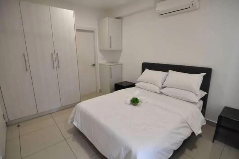 Bedroom features: queen-size bed with white bedding, upholstered headboard in black, 2 bedside tables in black, built-in wardrobe with white finish, white painted walls, tile flooring, wall-mounted air conditioning unit, small cabinet next to wardrobe; style: modern.