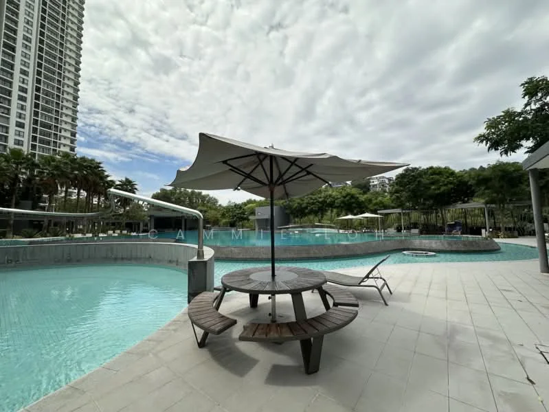 Exterior type: swimming pool deck; features: infinity pool, pool deck with loungers, circular wooden table, umbrella over table, paved flooring, surrounded by palm trees, landscaped greenery, modern high-rise building in background; style: modern.