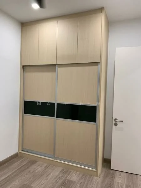 Room features: built-in wardrobe with sliding doors, light wood finish, glass panel inserts, minimalist design, neutral wall color, laminate flooring, modern handles, top cabinets; style: modern.