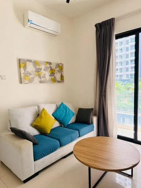 Living features: 3-seater fabric sofa in white with blue and yellow cushions, round wooden coffee table, floor-to-ceiling windows, sheer curtains, wall-mounted split AC, decorative wall art with geometric pattern, cream painted walls, glossy tile flooring; style: modern; view: garden.