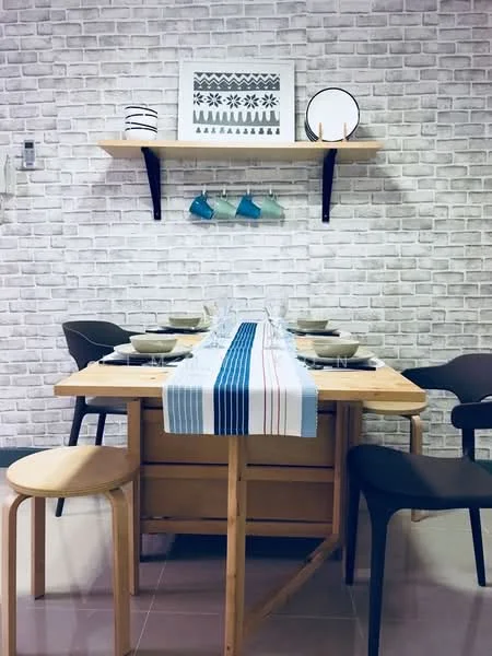 Dining features: wooden dining table, 4 dining chairs, table runner with blue and red stripes, white ceramic plates, glassware, shelf above table, decorative wall art, exposed brick wall, grey flooring; style: modern.