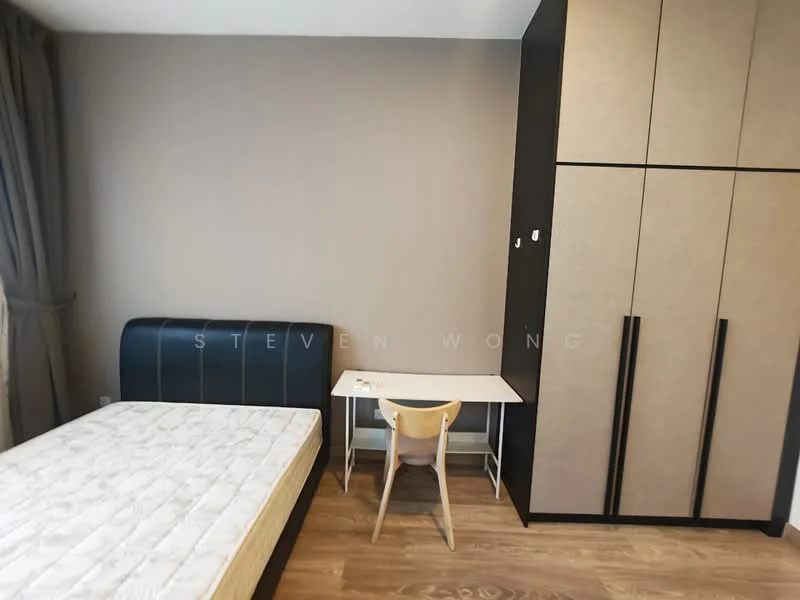 Bedroom features: queen-size bed frame without mattress, black upholstered headboard, light wood flooring, built-in wardrobe with black and beige panels, white desk with light wood legs, light wood chair, grey curtains, neutral painted walls; style: modern.