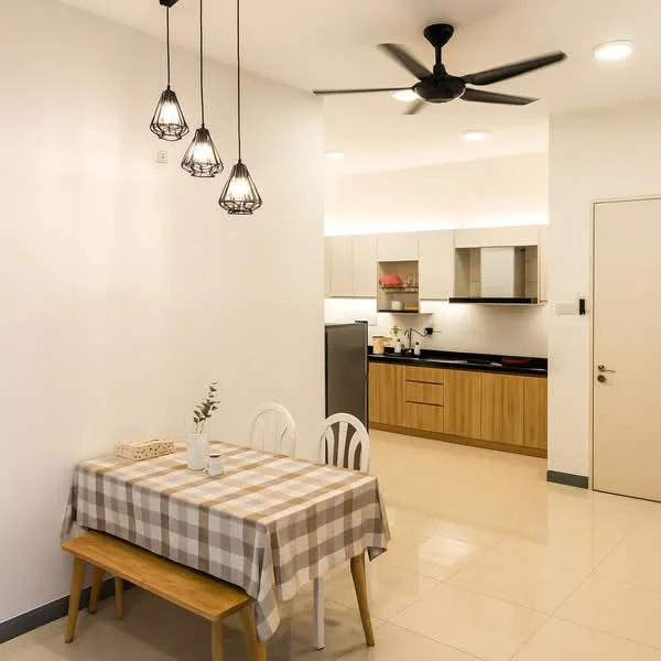 Dining features: 4-seater dining table with checkered tablecloth, white dining chairs, pendant lights with wire frames, wall-mounted light fixtures, cream painted walls, glossy tile flooring, ceiling fan, open layout to kitchen, kitchen cabinetry with wood finish, black countertop, stainless-steel fridge, built-in kitchen appliances; style: modern. Kitchen features: black countertop, wood cabinetry, built-in appliances, stainless-steel fridge; style: modern.