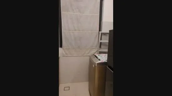 Laundry features: washing machine, window with sheer curtains, tile flooring, white walls, shelving unit, countertop, light fixture.