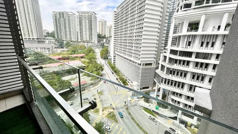Room features: glass railing, balcony flooring, city view, surrounding high-rise buildings, urban landscape, roadway, greenery, skyline, outdoor space; style: modern; view: city.