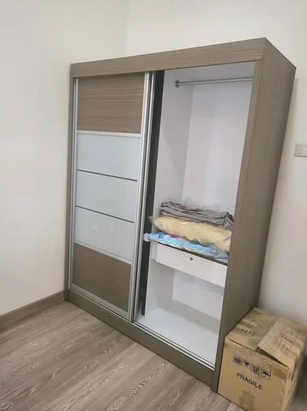 Room features: sliding wardrobe with mirrored doors, wooden cabinetry with horizontal paneling, interior shelving, drawer for storage, light-colored wooden flooring, neutral wall color, box labeled 'FRAGILE' on the floor; style: modern.