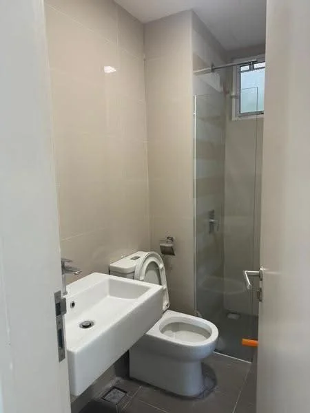 Bathroom features: white wall tiles, grey floor tiles, single-sink vanity with wall-mounted faucet, one-piece toilet, walk-in shower with glass enclosure, chrome shower head, window for natural light, mirror above sink; style: modern.