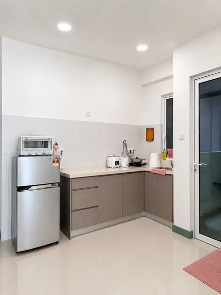 Kitchen features: stainless-steel fridge, built-in microwave, countertop with beige surface, grey cabinetry, sink with faucet, kettle, toaster, tile backsplash, recessed ceiling lights, sliding glass door, cream painted walls, ceramic tile flooring; style: modern.