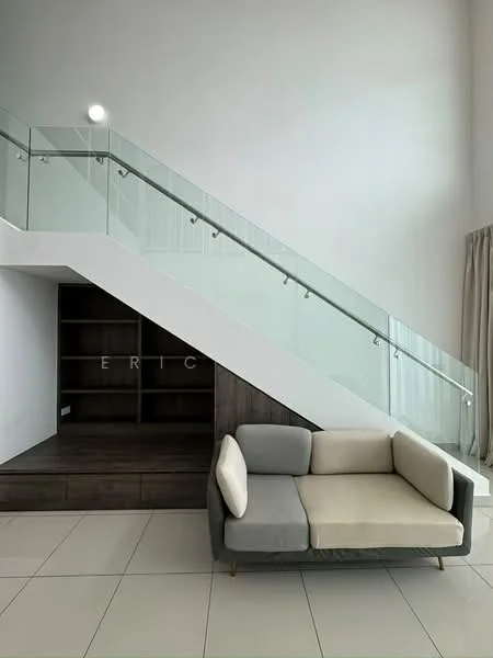 Living features: grey and beige fabric sofa, glass railing on staircase, white painted walls, tile flooring, built-in wooden shelving under staircase, large windows with natural light, curtains, open space layout; style: modern.