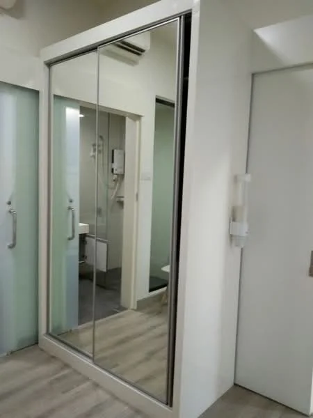 Room features: mirrored sliding wardrobe, white cabinetry, light wood flooring, wall-mounted air conditioning unit, grey tiled flooring, white walls, door with handle, glass door; style: modern.