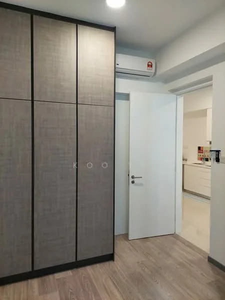 Room features: built-in wardrobe with grey finish, white door, wall-mounted split AC, light-colored laminate flooring, neutral wall color, recessed ceiling lights, open doorway leading to another room, kitchen visible in background; style: modern.