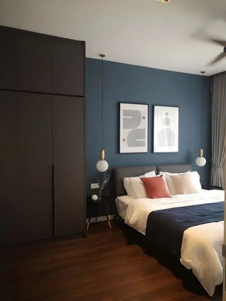 Bedroom features: king-size bed with white bedding, upholstered headboard, two bedside lamps with pendant lighting, dark wood flooring, blue accent wall, built-in wardrobe with dark cabinetry, framed artwork on walls, curtains, nightstand with decorative items; style: modern.