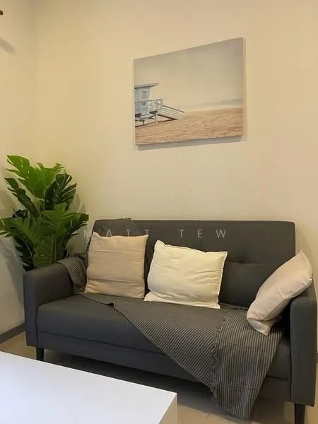 Living features: grey fabric sofa, two decorative cushions in cream and beige, striped throw blanket, white coffee table, framed artwork on wall, indoor plant, light-colored walls, tile flooring; style: modern.