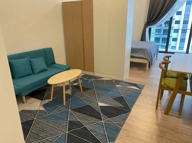 Living features: teal fabric sofa, round wooden coffee table, area rug with geometric pattern, wooden flooring, floor-to-ceiling windows, grey curtains, light-colored cabinetry, bed in background; style: modern.
