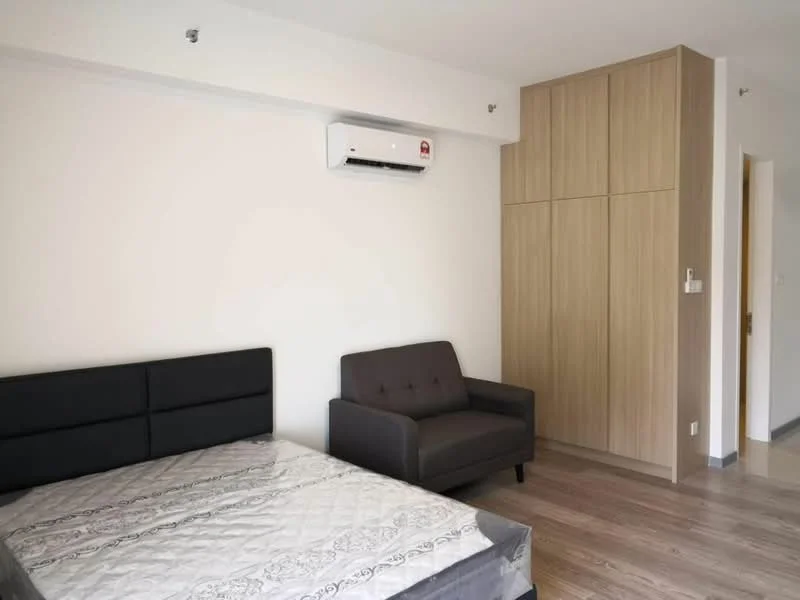 Bedroom features: queen-size bed, upholstered headboard, grey fabric sofa, built-in wardrobe with wooden finish, wall-mounted split AC, light-colored walls, laminate flooring, window with natural light; style: modern.