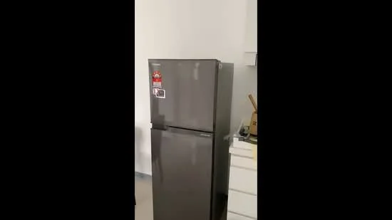 Room features: fridge in dark grey finish, white walls, light grey flooring, countertop, kitchen utensils visible.