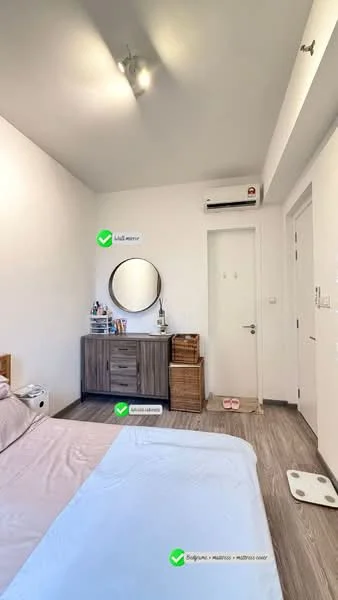 Bedroom features: white painted walls, laminate flooring, recessed downlights, wall-mounted split AC, round mirror, wooden dresser, wooden storage baskets, bed with light-colored bedding, sliding door, door handle, floor mat; style: modern.