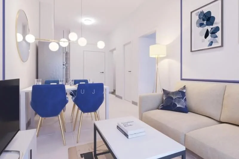 Living features: light grey fabric sofa, white coffee table, round mirror on wall, pendant light fixture with multiple bulbs, blue upholstered dining chairs with gold legs, white dining table, decorative artwork on wall, floor lamp, neutral wall color, light-colored flooring; style: modern.