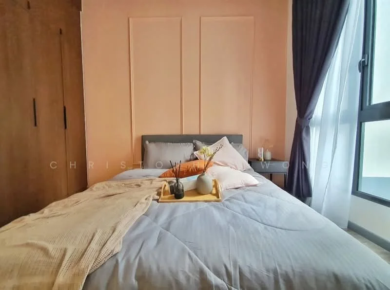Bedroom features: king-size bed with grey bedding, upholstered headboard, wooden bedside table, decorative tray with plants and accessories, floor-to-ceiling window with sheer curtains, light pink painted walls, built-in wardrobe with wooden doors, grey area rug; style: modern.