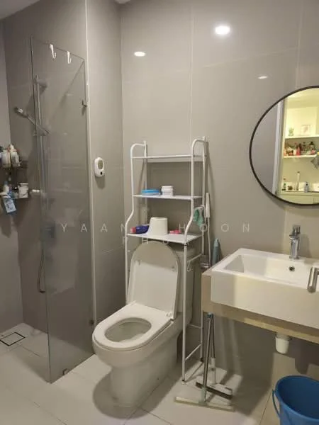Bathroom features: walk-in shower with glass enclosure, chrome handheld shower head, one-piece toilet, single-sink vanity with white cabinet, round mirror, grey tiled walls, white tiled flooring, open shelving unit, wall-mounted soap dispenser, toiletries storage, recessed lighting; style: modern.