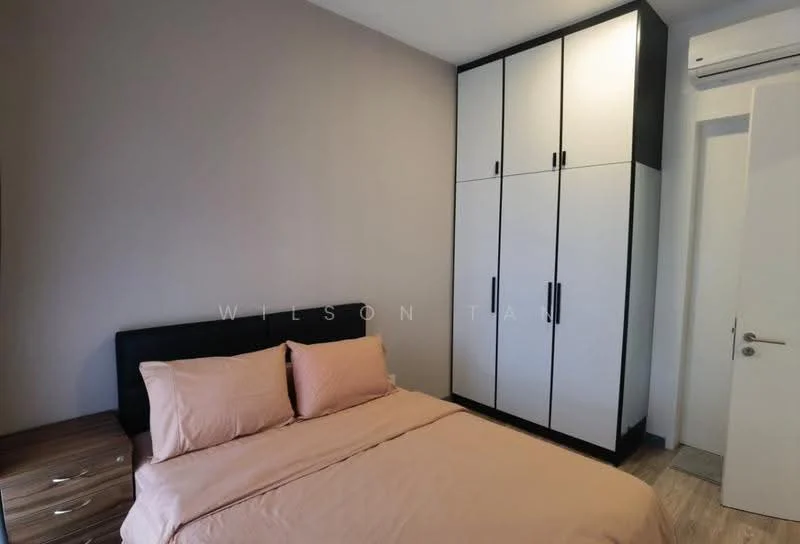 Bedroom features: queen-size bed with pink bedding, black upholstered headboard, built-in wardrobe with white and black doors, wooden bedside table, laminate flooring, wall-mounted air conditioning unit, light grey painted walls, white door with silver handle; style: modern.