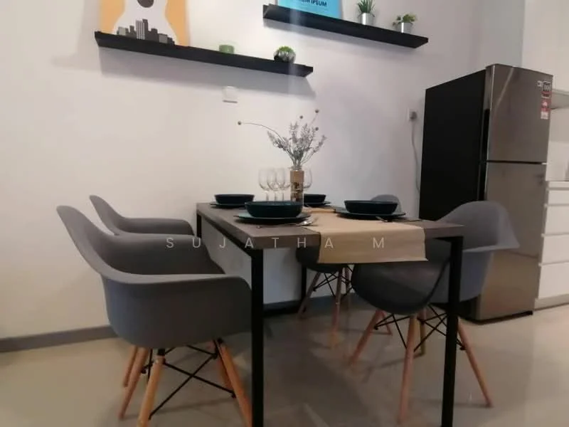 Dining features: 4-seater dining table, black metal table legs, light wood tabletop, grey upholstered dining chairs, decorative table runner, set of four dinner plates, set of four wine glasses, wall-mounted shelves, decorative vase with flowers, refrigerator in background, white cabinetry in background, neutral wall color, polished tile flooring; style: modern.