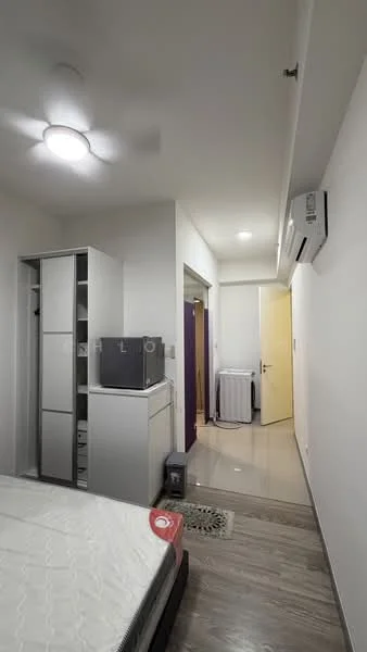 Room features: white painted walls, ceiling with recessed lighting, 5-blade ceiling fan, tile flooring, built-in wardrobe, wall-mounted air conditioning unit, door leading to hallway, laundry area with washing machine, bed with mattress, TV unit, decorative wall panel, floor drain; style: modern.