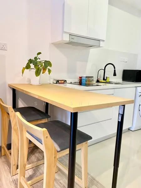 Kitchen features: white cabinetry, stainless-steel range hood, black gooseneck faucet, single-bowl stainless-steel sink, white countertop, built-in stove, microwave, washing machine, wooden bar table, 2 wooden stools with grey cushions, potted plant, light-colored laminate flooring; style: modern.
