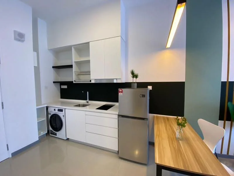 Kitchen features: white cabinetry, black accent wall, stainless-steel fridge, built-in oven, ceramic cooktop, single-bowl stainless-steel sink, chrome pull-down faucet, front-load washing machine, wood dining table, white dining chair, recessed downlights, tile flooring; style: modern.