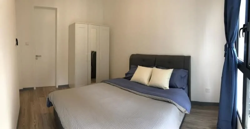 Bedroom features: queen-size bed with grey upholstered headboard, two decorative pillows in cream and blue, light grey bedding, wooden flooring, white painted walls, built-in wardrobe with mirrored doors, curtains in dark blue, floor-to-ceiling window, natural light from window; style: modern.