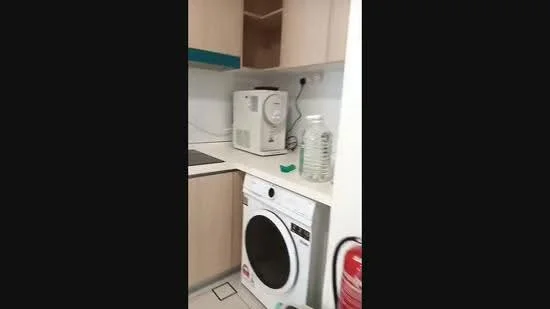 Laundry features: front-load washing machine, white cabinetry, light wood cabinetry, countertop, microwave, water dispenser, fire extinguisher, tile flooring; style: modern.