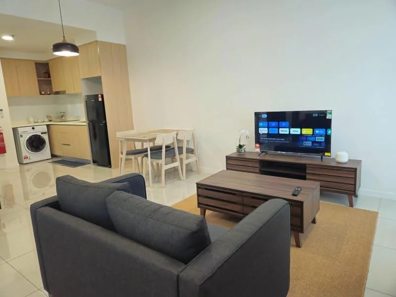 Living features: 3-seater fabric sofa in grey, coffee table, wall-mounted TV, TV console, area rug, recessed downlights, white painted walls, ceramic tile flooring; style: modern. Kitchen features: single-bowl stainless-steel sink, chrome pull-down faucet, built-in oven, freestanding range oven, microwave, stainless-steel fridge, white cabinetry, countertop with backsplash, washing machine; style: modern. Dining features: 4-seater dining table, wooden dining chairs; style: modern.