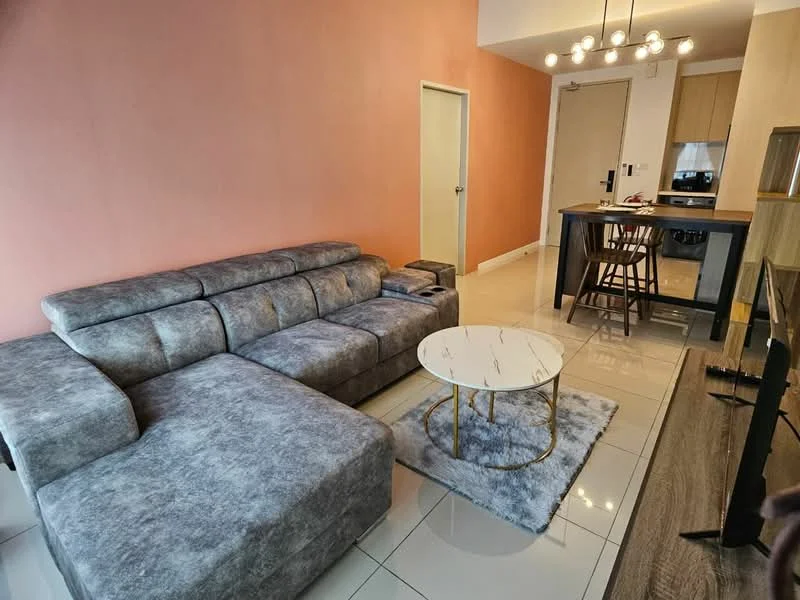 Living features: L-shape sectional sofa in grey, marble-top coffee table, area rug with geometric pattern, wall-mounted TV, pendant lighting fixture, cream painted walls, glossy tile flooring, open-plan layout with kitchen, bar stools at kitchen counter, door leading to hallway, recessed lighting; style: modern.
