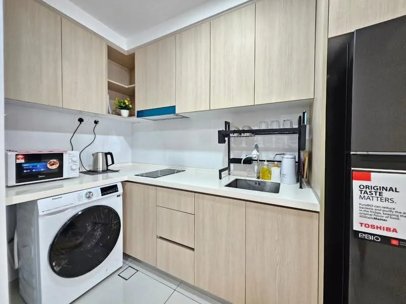Kitchen features: light wood cabinetry, white countertop, built-in electric stove, stainless-steel sink, chrome pull-down faucet, microwave, white front-load washing machine, kettle, open shelving, glassware on shelf, refrigerator with black finish; style: modern.