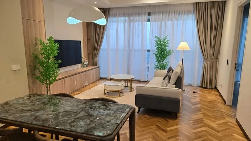 Living features: light wood herringbone flooring, cream area rug, grey fabric sofa, white coffee table with gold base, wooden TV console, wall-mounted TV, green potted plants, floor lamp, large windows with sheer curtains, recessed ceiling lights, pendant light fixture; style: modern.