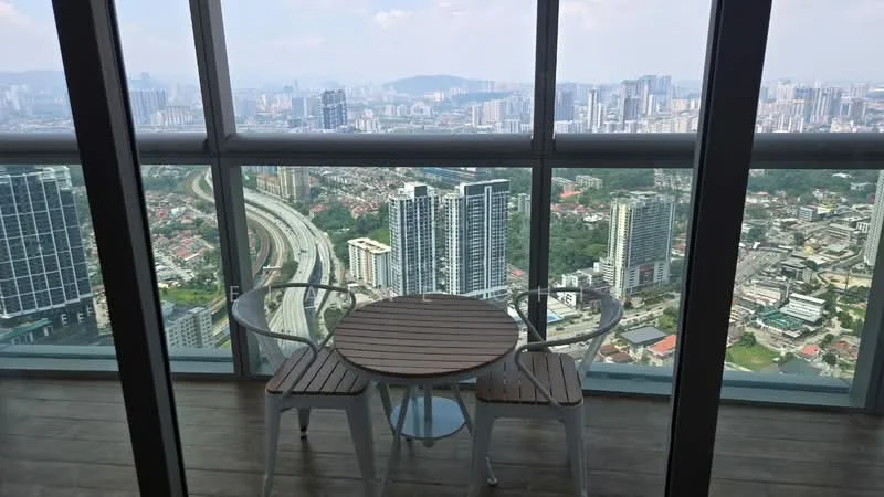 Balcony features: glass railing, wooden flooring, round wooden table, two white chairs, city skyline view; style: modern; view: city.