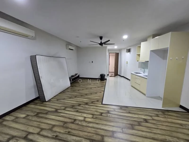 Room features: laminate wood flooring, white painted walls, ceiling fan, wall-mounted air conditioning unit, kitchenette with light-colored cabinetry, countertop, sink, refrigerator, doorway leading to another room, waste bin, mattress on the floor; style: modern.