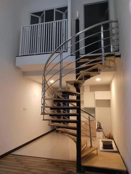Room features: spiral staircase with wooden steps, metal railing, white walls, recessed downlights, open space layout, large windows, balcony with railing, kitchen area visible, laminate flooring, neutral color palette; style: modern.