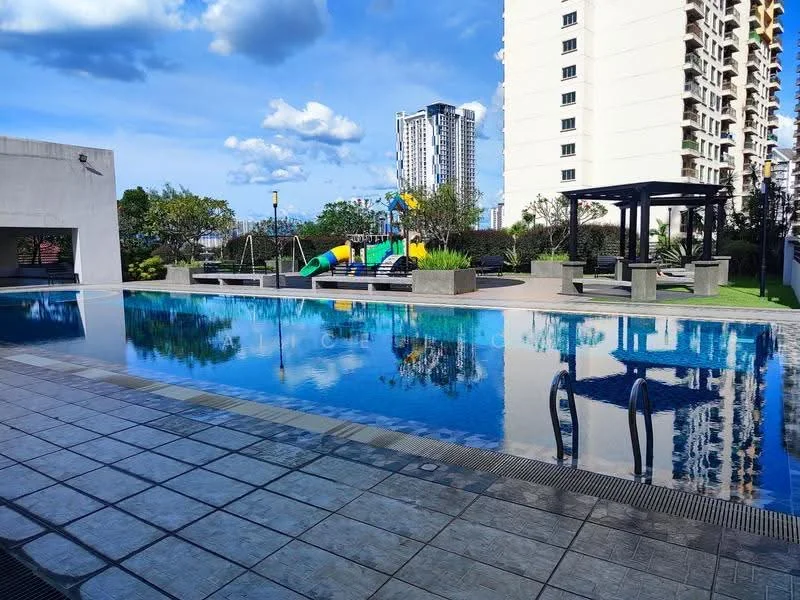 Exterior type: swimming pool deck; features: infinity pool, pool deck with loungers, children's playground, slide, swing set, manicured landscaping, modern pergola, tropical trees, city skyline in background, clear blue sky, reflections on water surface; style: modern.