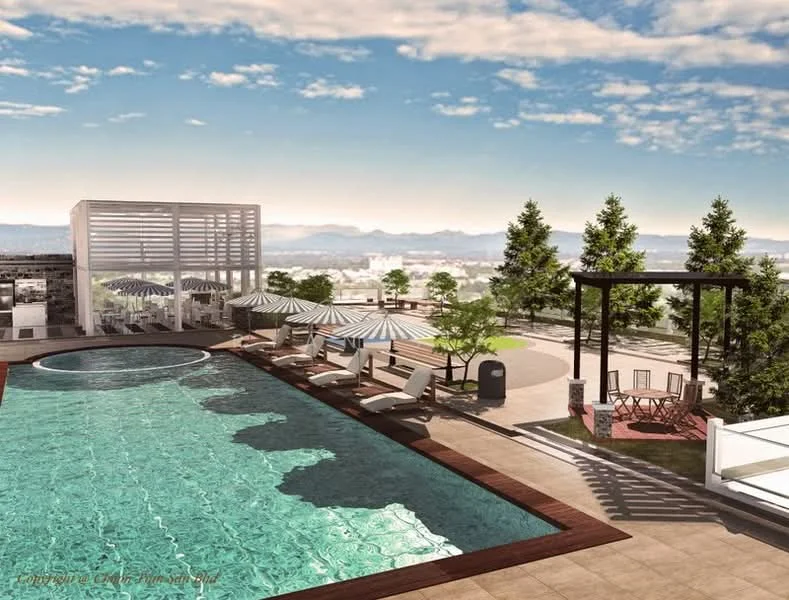 Exterior type: swimming pool deck; features: infinity pool, pool deck with loungers, jacuzzi, outdoor dining pavilion, landscaped garden with trees, shaded seating area with pergola, stone-paved walkway, umbrella-covered lounge chairs; style: modern.