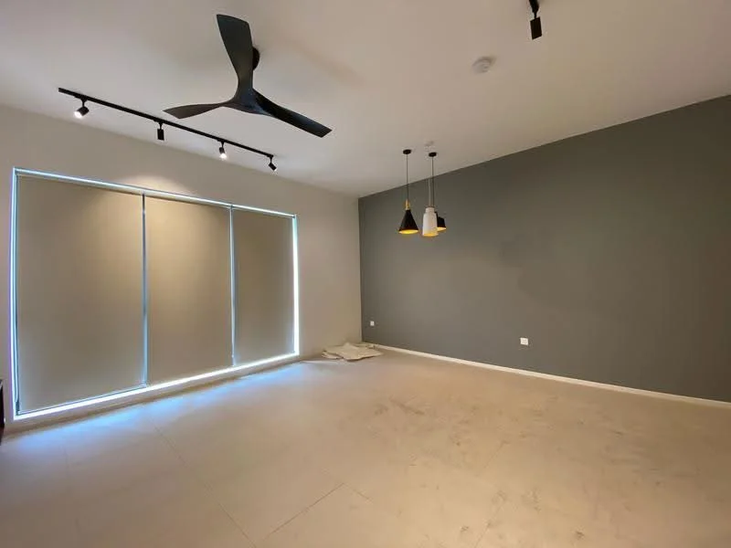 Living features: 5-blade ceiling fan, recessed LED downlights, grey accent wall, white walls, large windows with roller blinds, neutral tile flooring, hanging pendant lights, open layout; style: modern.