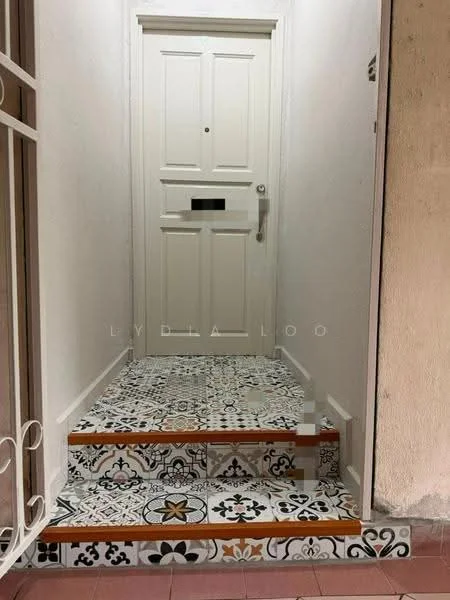 Room features: decorative patterned floor tiles, white painted walls, wooden door with paneling, door handle, mail slot, staircase with wooden steps, decorative tile risers; style: modern.