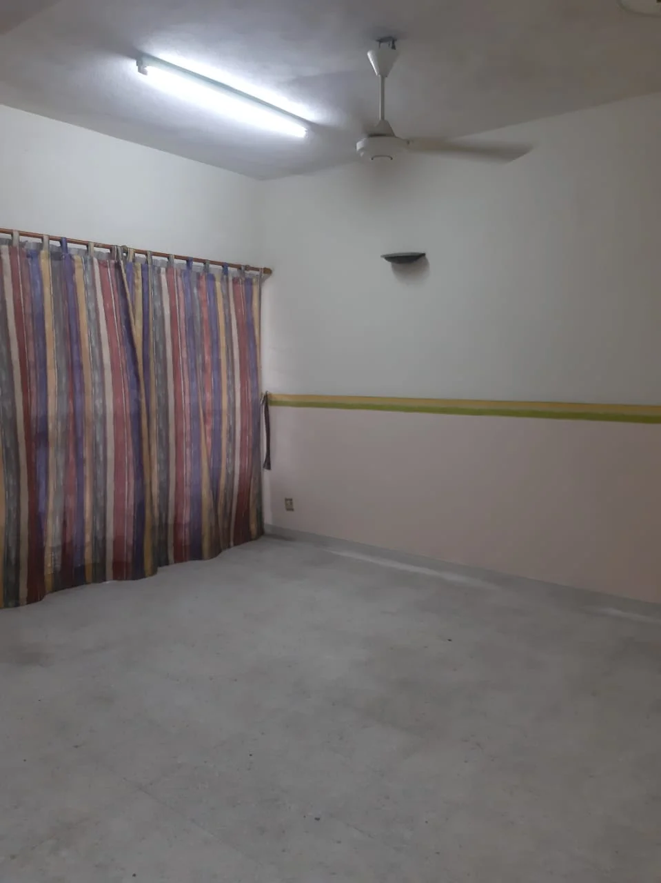 Room features: striped curtains, ceiling fan, fluorescent ceiling lights, plain white walls, light-colored flooring, yellow accent stripe on wall; style: minimalist.