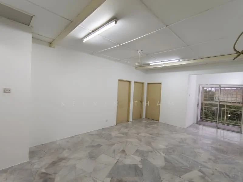Room features: white painted walls, marble flooring, ceiling fan, three doors, large window with metal grille, natural light from window, exposed ceiling lights.