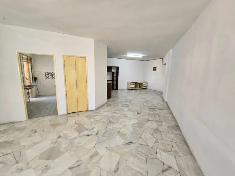 Room features: white painted walls, marble flooring, single wooden door, built-in shelving unit, open layout, fluorescent ceiling light.