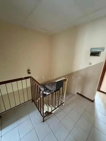 Room features: white painted walls, light brown wooden railing, ceramic tile flooring, staircase leading up, wall-mounted electrical outlet, doorway leading to another room.
