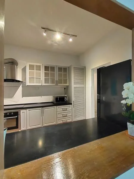 Kitchen features: black countertop, grey cabinetry with glass-front upper cabinets, built-in oven, microwave, stainless-steel range hood, kitchen sink, refrigerator, white tiled backsplash, recessed downlights, ventilation louvered door, open layout to living area; style: modern.