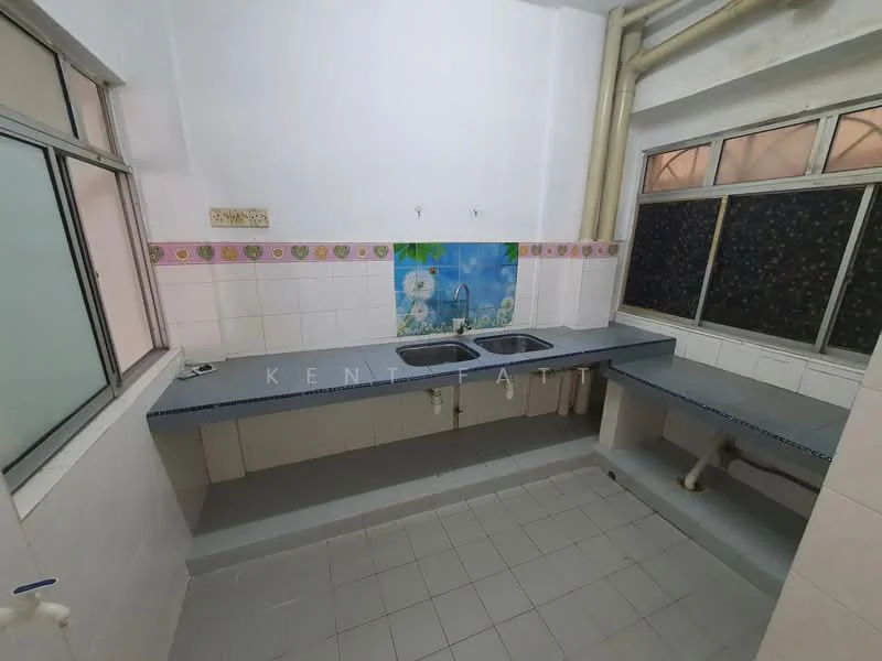 Kitchen features: double-bowl stainless-steel sink, chrome faucet, blue countertop, white tiled backsplash, white tiled walls, grey tiled flooring, window with sliding glass, under-sink plumbing visible, decorative border tile, natural light from window.